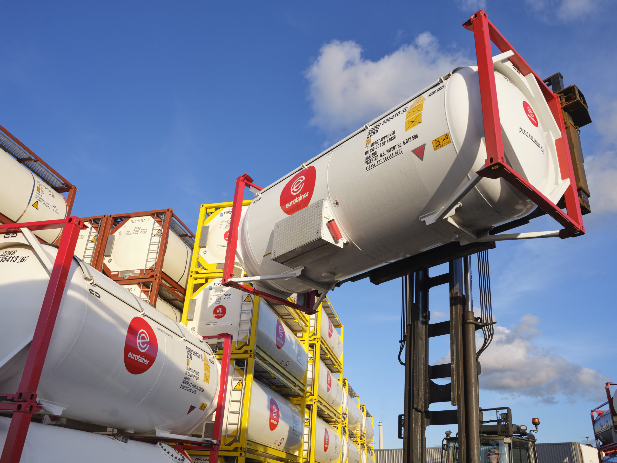 Eurotainer gas tank on lift in the air next to tanks stacked